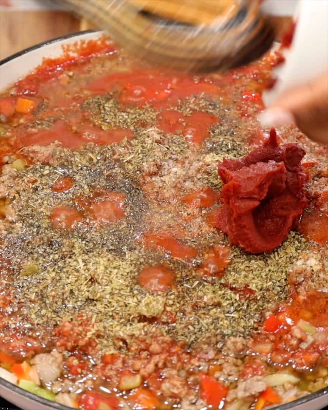 ADDING TOMATO PASTE TO MIXTURE