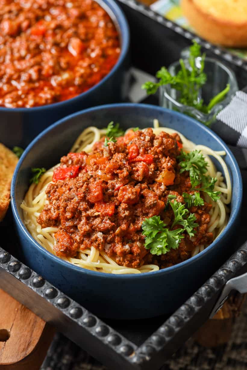 spaghetti bolognese garnished with fresh parsley