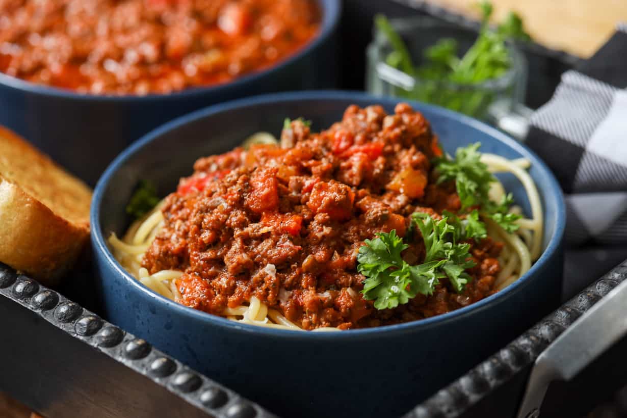 beef bolognese garnished with parsley
