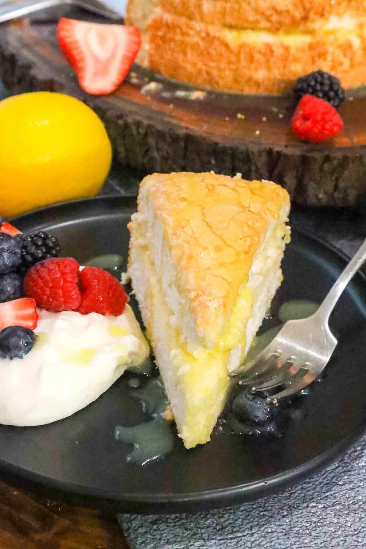 Angel Food Cake Recipe on black plate with fruits