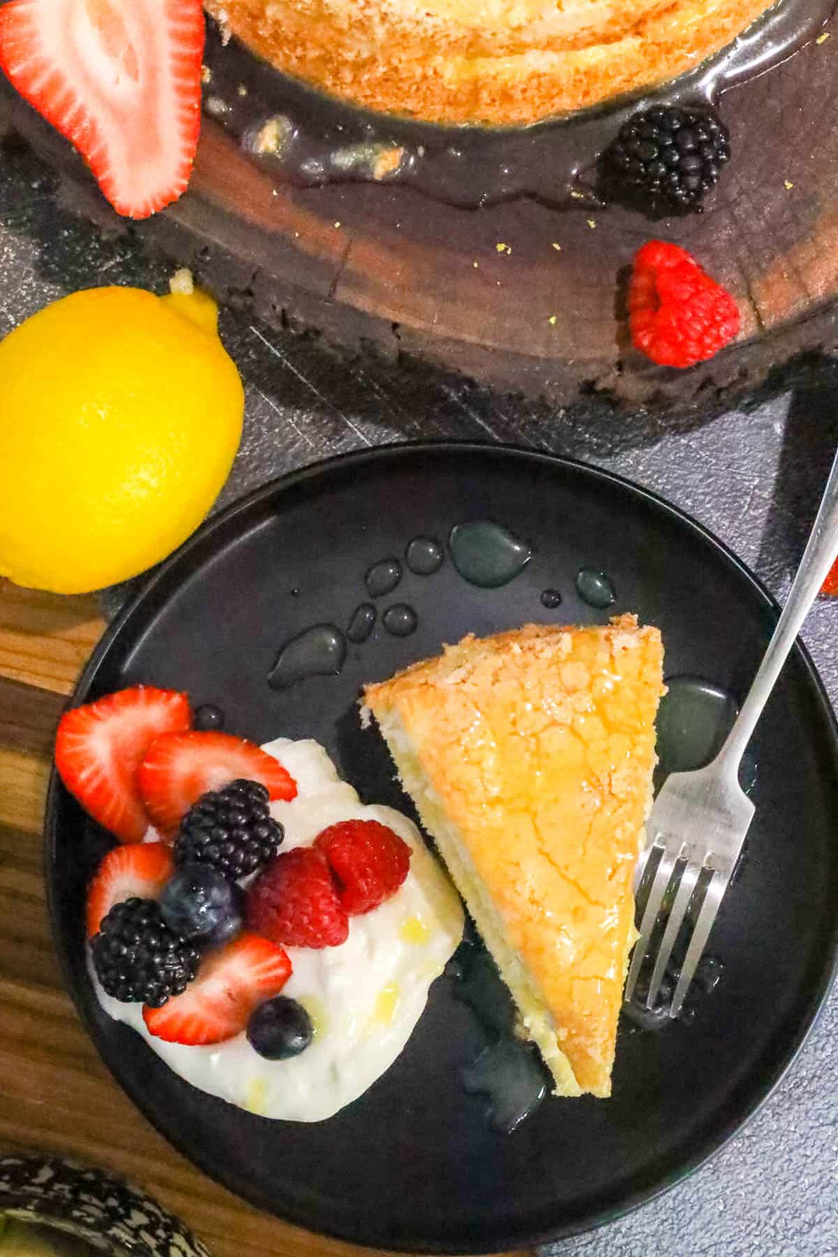 Angel Food Cake Recipe on black plate with fruits