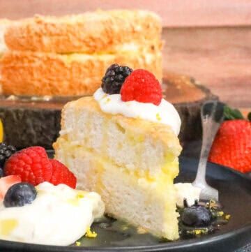 Angel Food Cake Recipe on black plate with fruits