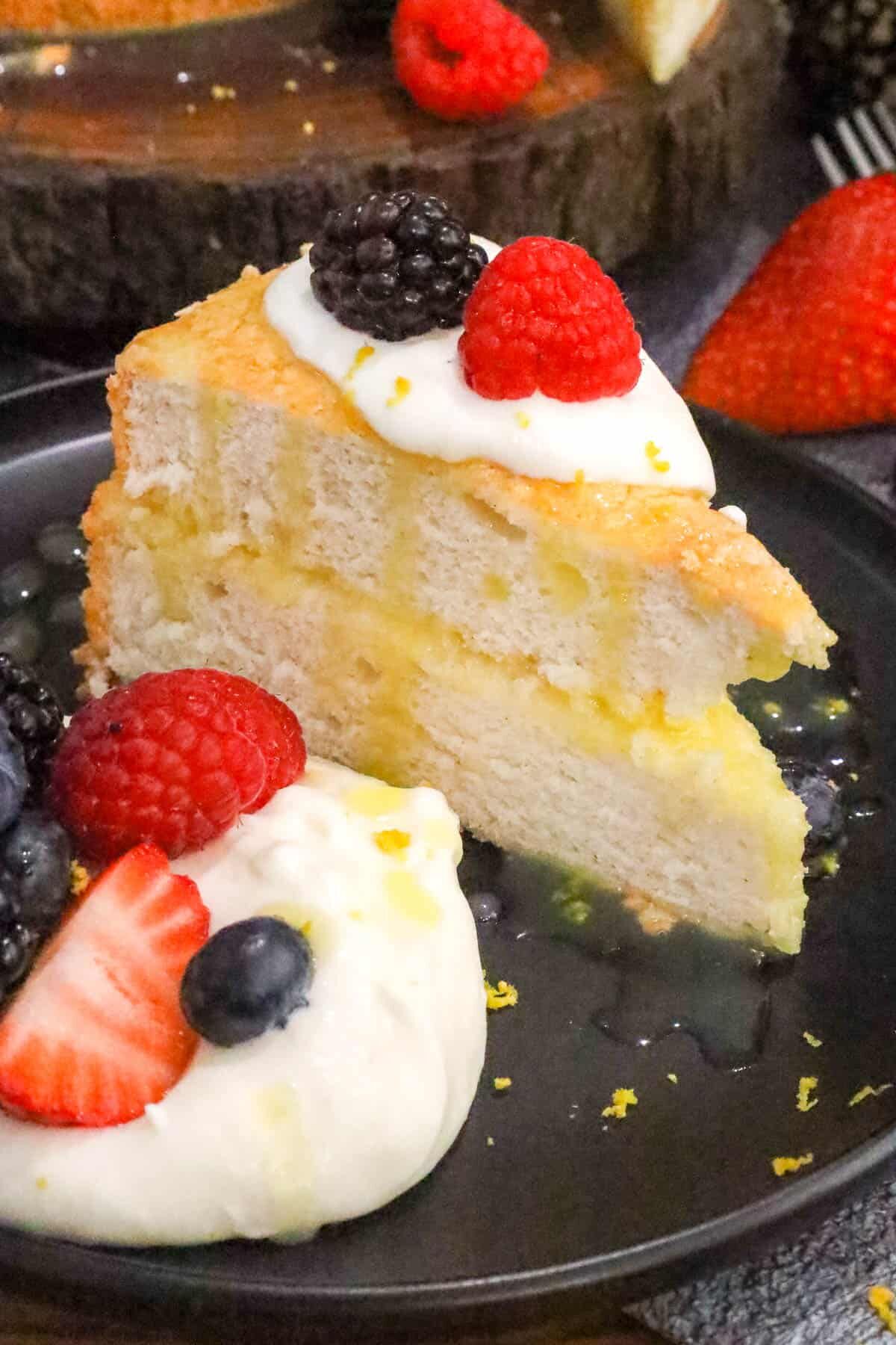 Angel Food Cake Recipe on black plate with fruits