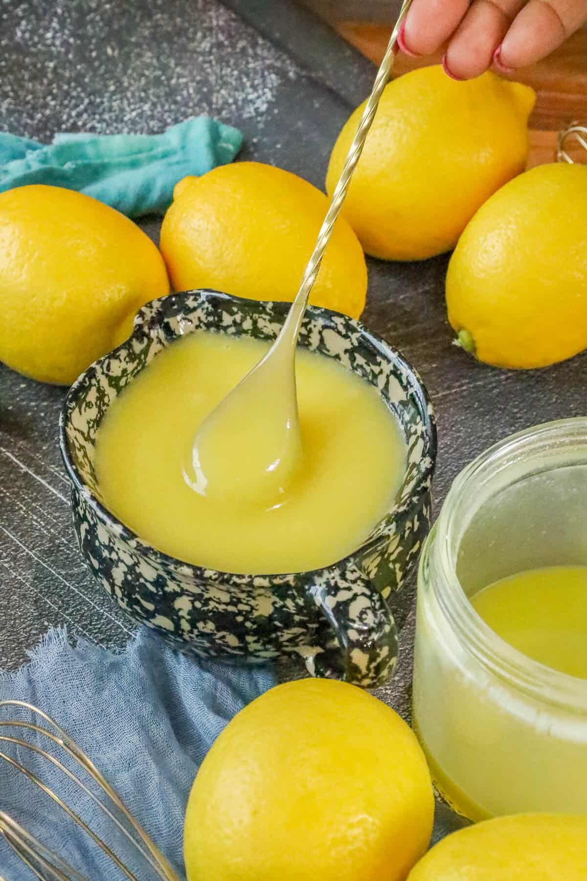 spoon lifting lemon sauce for desserts