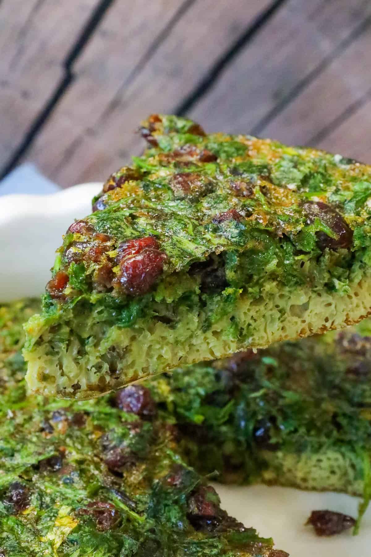 lifting slice of Kuku sabzi